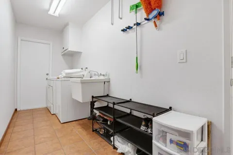 a room with a table chairs and appliances
