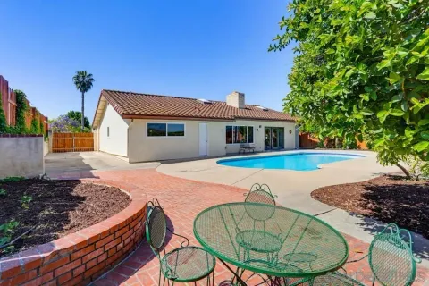 a house with swimming pool in front of it