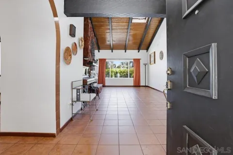 a view of entryway with a floor to ceiling window and a kitchen