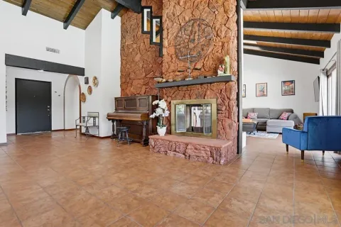 a view of livingroom with furniture and a fireplace
