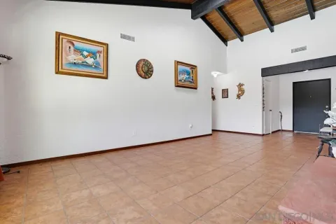 a view of a livingroom with wooden floor and a workspace