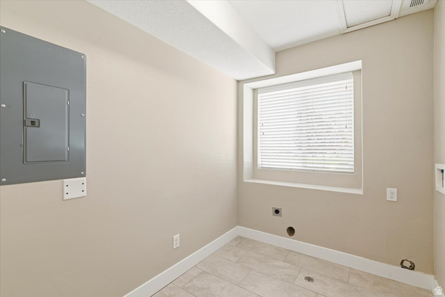 847 225 South Springville, UT 84663 - Photo 9 of 23 Compact utility space featuring a window with blinds, light beige wall paint, white baseboards, and tile flooring.