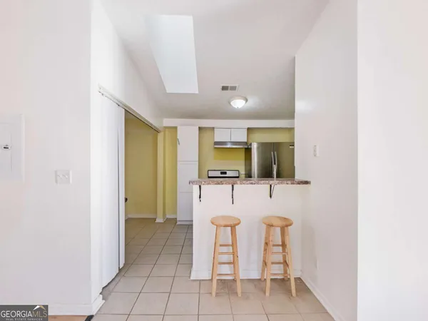 a dining room with furniture and a window