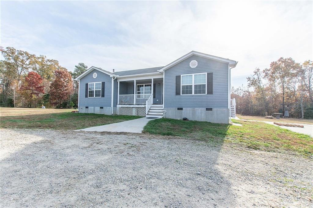 a view of a house with yard and tree s