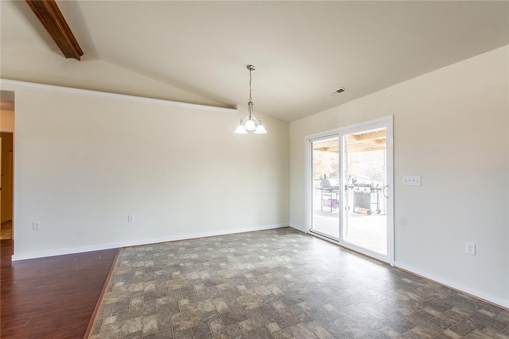 9481 Sturgeon Point Road Charles City, VA 23030 - Photo 11 of 44 an empty room with chandelier fan and windows