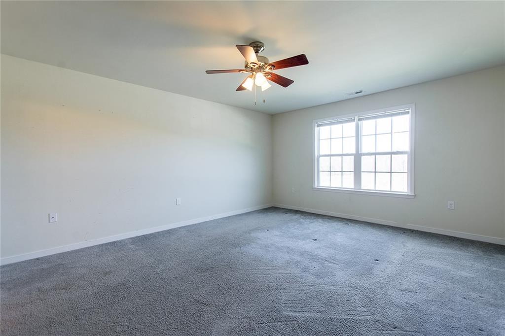 9481 Sturgeon Point Road Charles City, VA 23030 - Photo 13 of 44 an empty room with windows and ceiling fan