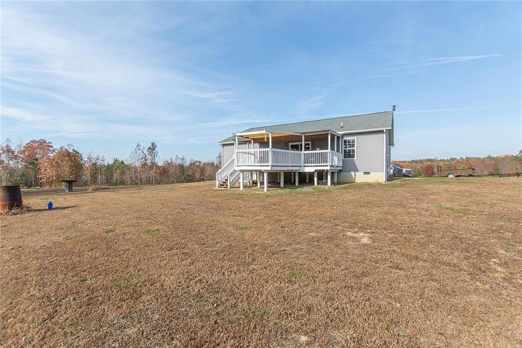 9481 Sturgeon Point Road Charles City, VA 23030 - Photo 18 of 44 a view of a house with a big yard and large trees