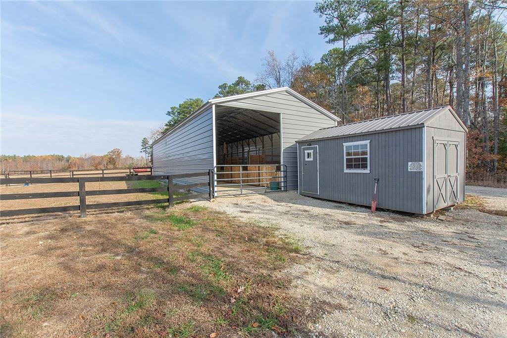 9481 Sturgeon Point Road Charles City, VA 23030 - Photo 25 of 44 a view of a house with a yard and wooden fence