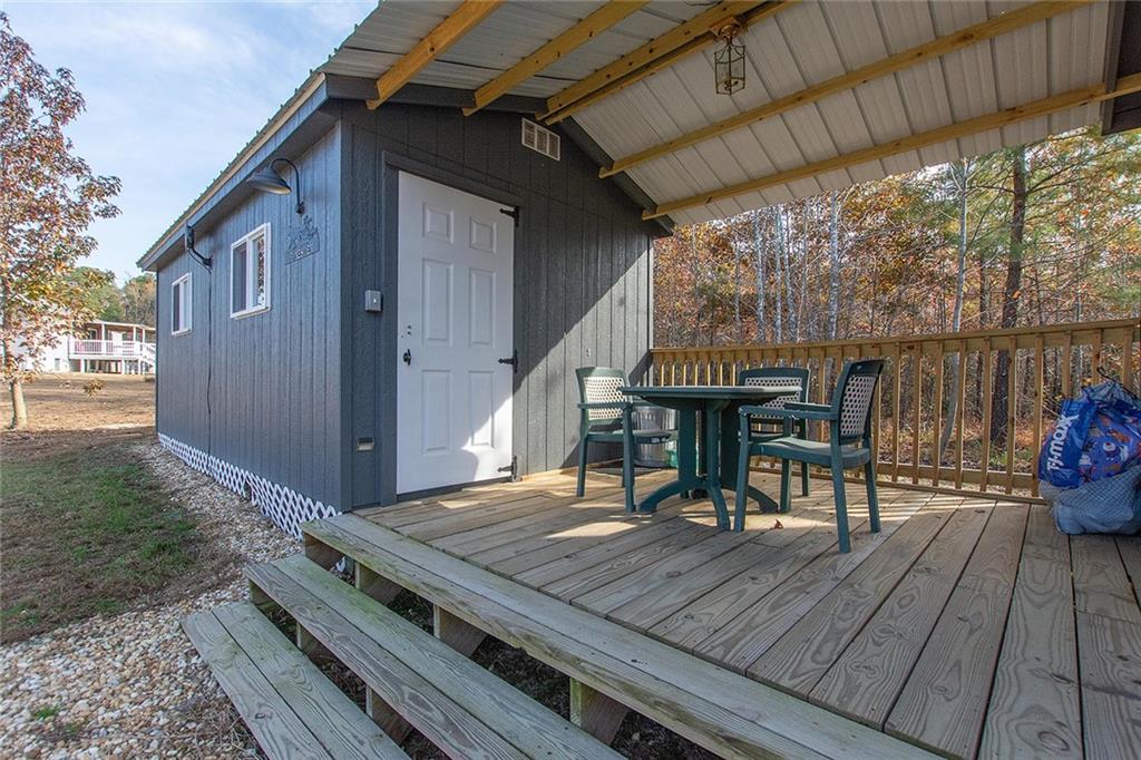9481 Sturgeon Point Road Charles City, VA 23030 - Photo 30 of 44 a view of a deck with wooden floor table and chairs