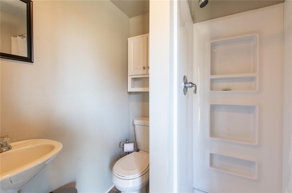 9481 Sturgeon Point Road Charles City, VA 23030 - Photo 34 of 44 a white toilet sitting next to a bathroom sink