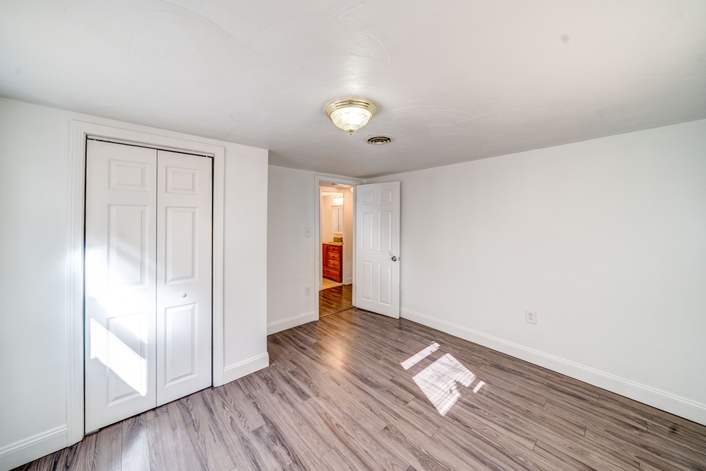 98 David Street Springfield, MA 01104 - Photo 18 of 26 an empty room with wooden floor and windows