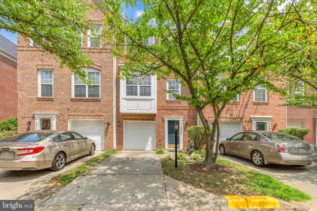 a view of a car parked in front of a brick house