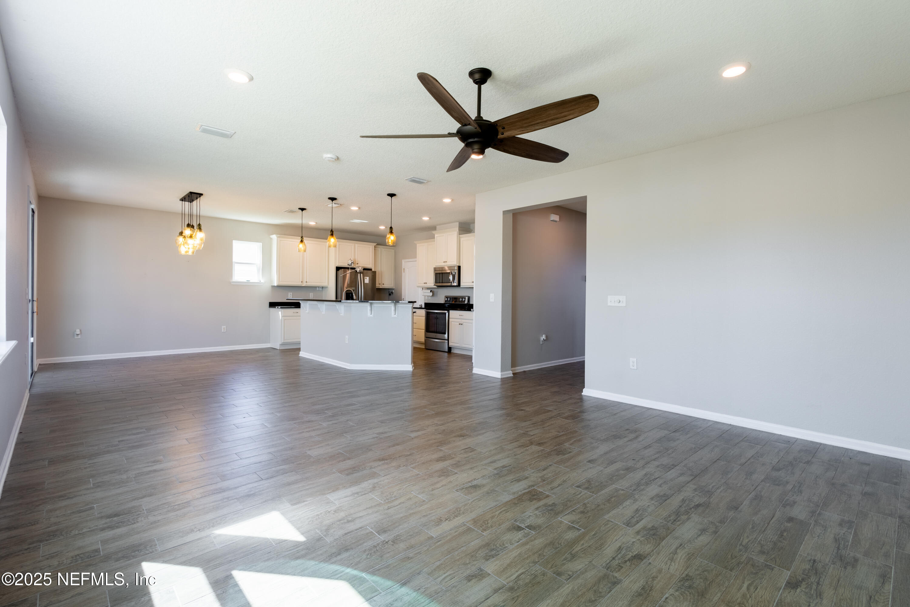 68 Redland Way Jacksonville, FL 32218 - Photo 11 of 40 a view of a livingroom with a ceiling fan wooden floor and a ceiling fan