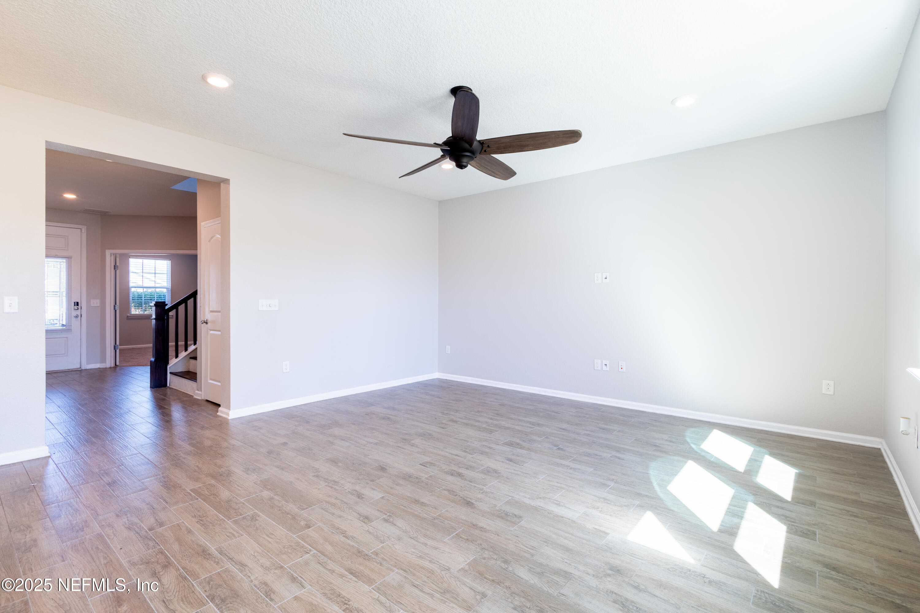 68 Redland Way Jacksonville, FL 32218 - Photo 12 of 40 a view of a room with wooden floor and a ceiling fan