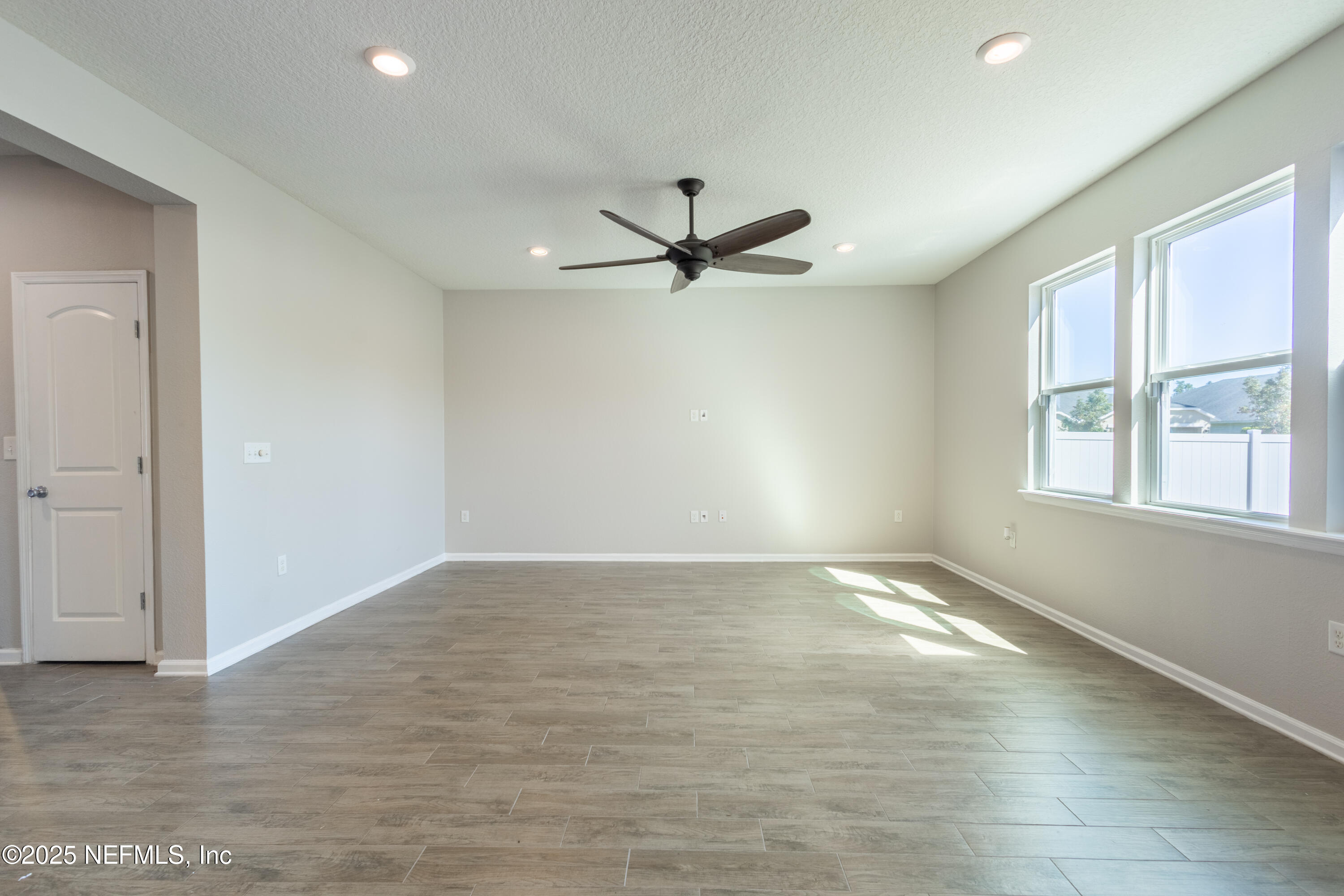 68 Redland Way Jacksonville, FL 32218 - Photo 13 of 40 wooden floor in an empty room with a window