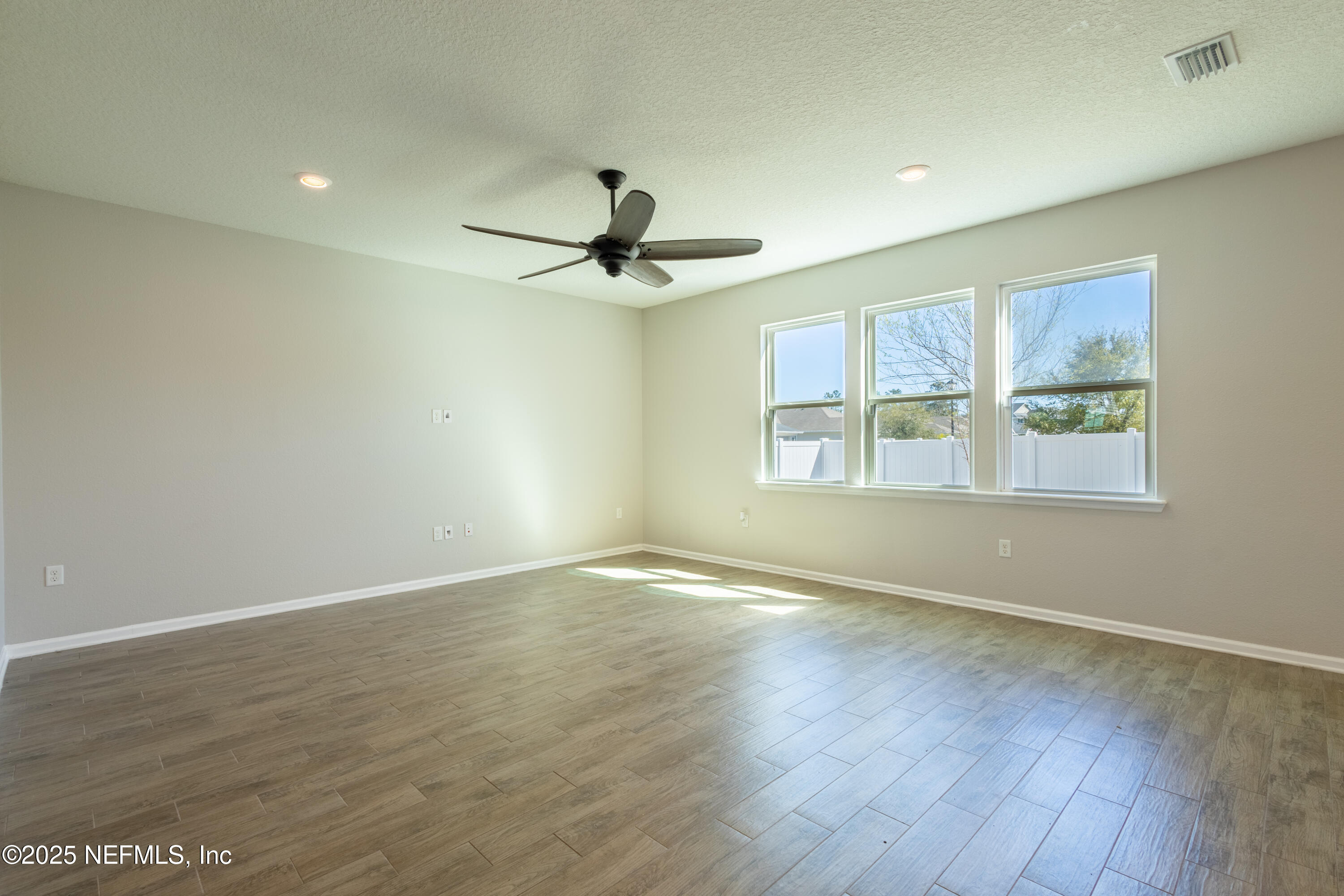 68 Redland Way Jacksonville, FL 32218 - Photo 14 of 40 a view of an empty room with a window and wooden floor