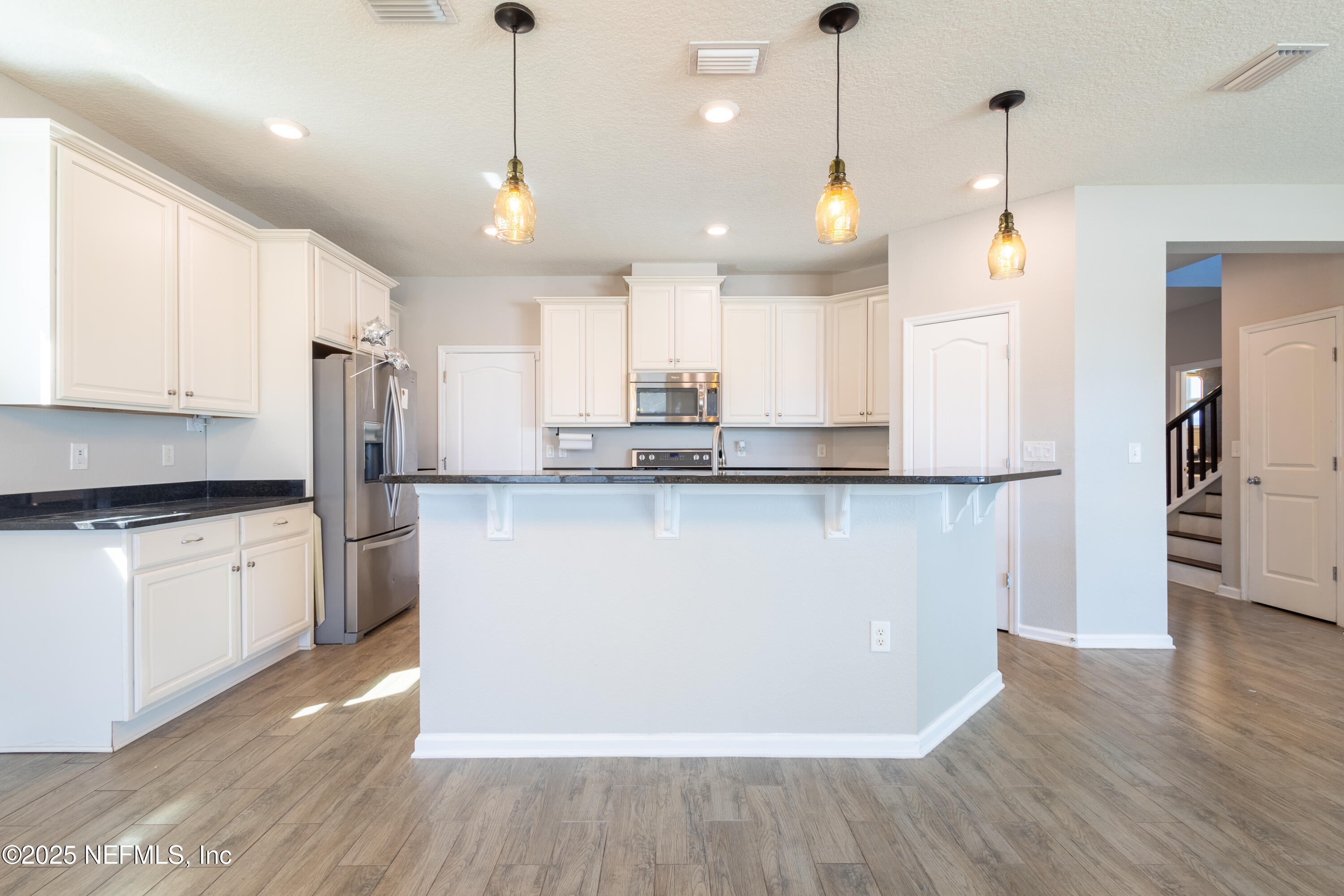 68 Redland Way Jacksonville, FL 32218 - Photo 17 of 40 a view of a kitchen with center island wooden floor and stainless steel appliances