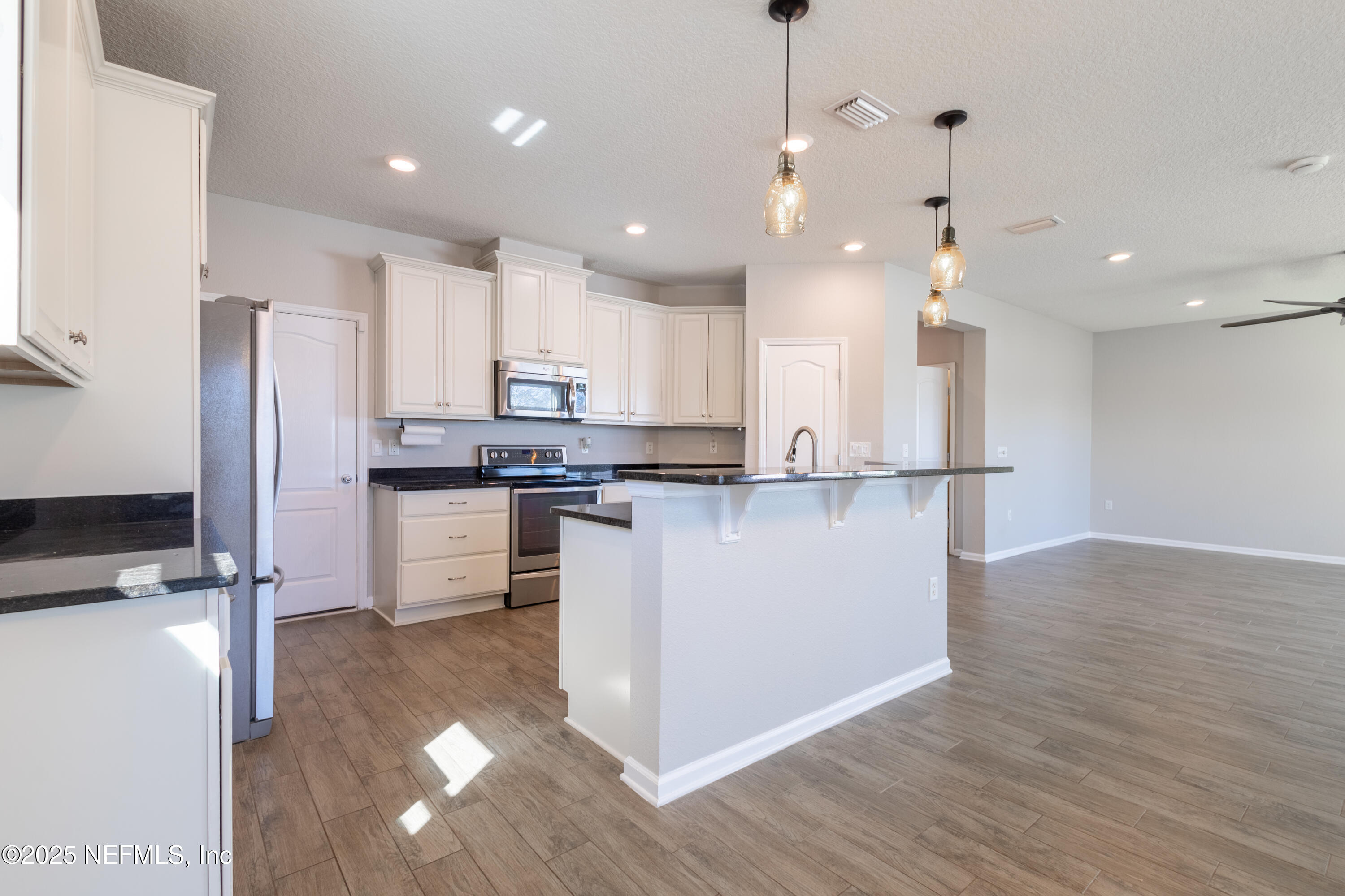 68 Redland Way Jacksonville, FL 32218 - Photo 18 of 40 a kitchen with stainless steel appliances granite countertop a refrigerator a stove a sink and a oven