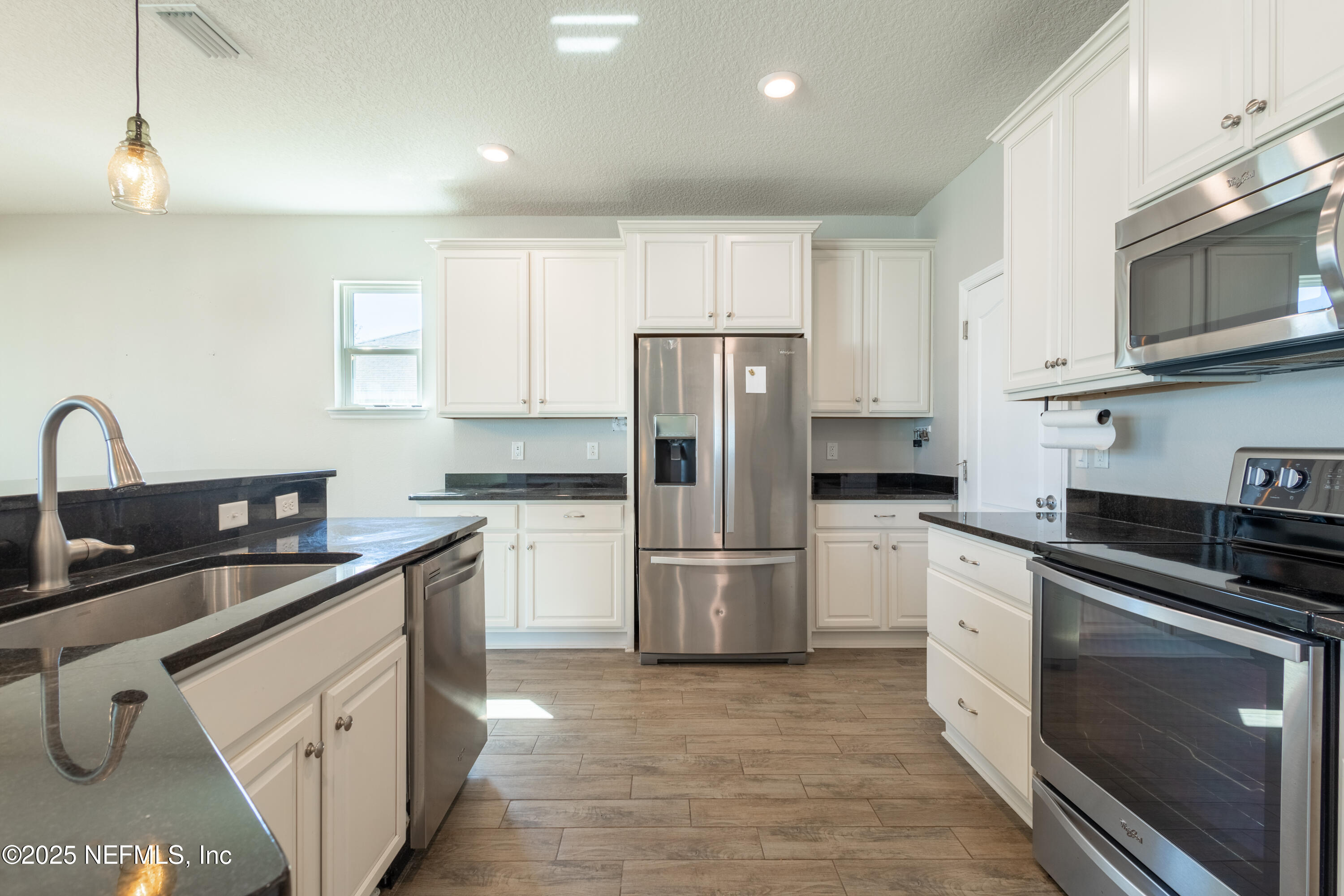 68 Redland Way Jacksonville, FL 32218 - Photo 19 of 40 a kitchen with a sink a stove and refrigerator