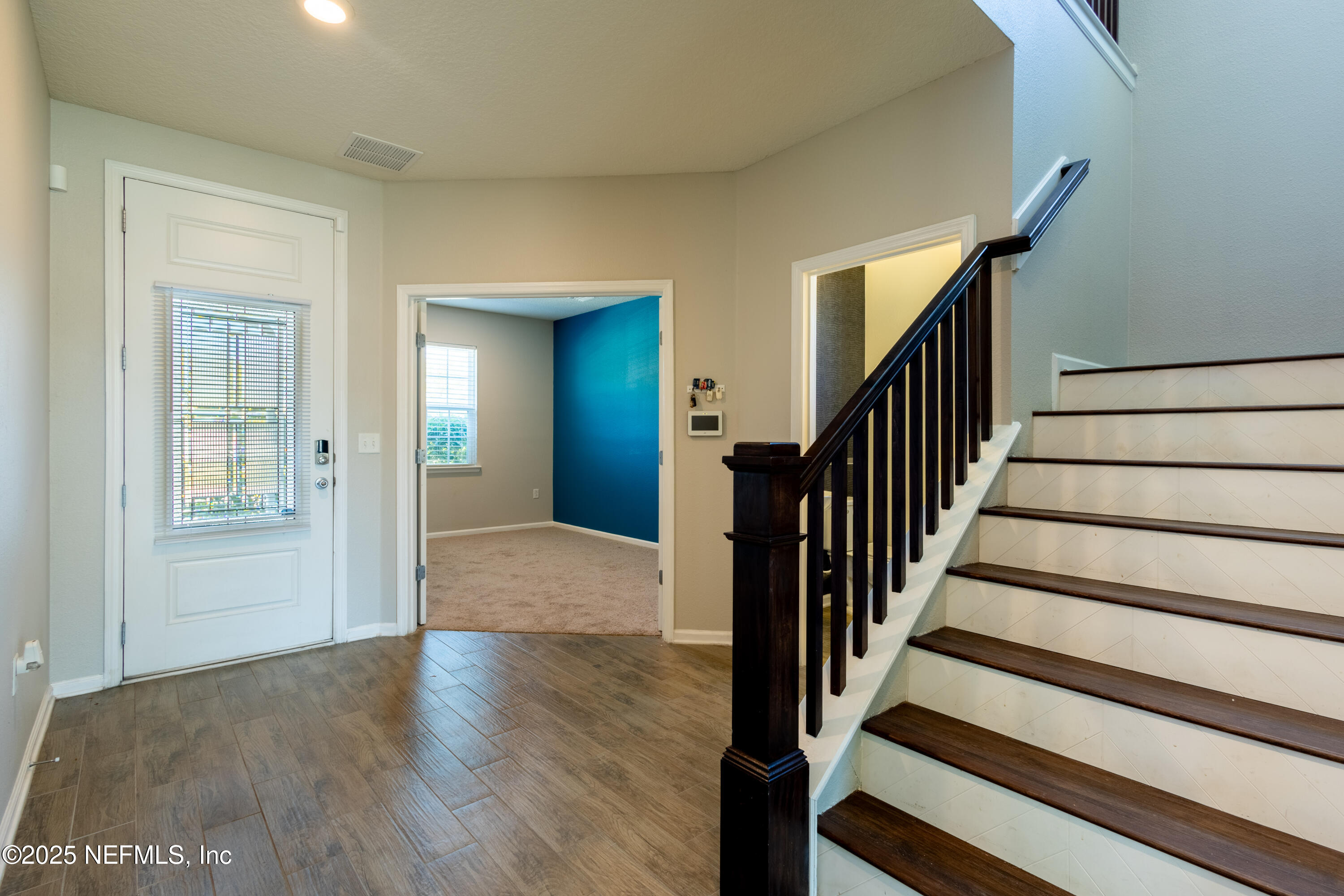 68 Redland Way Jacksonville, FL 32218 - Photo 21 of 40 a view of an entryway with wooden floor and stairs