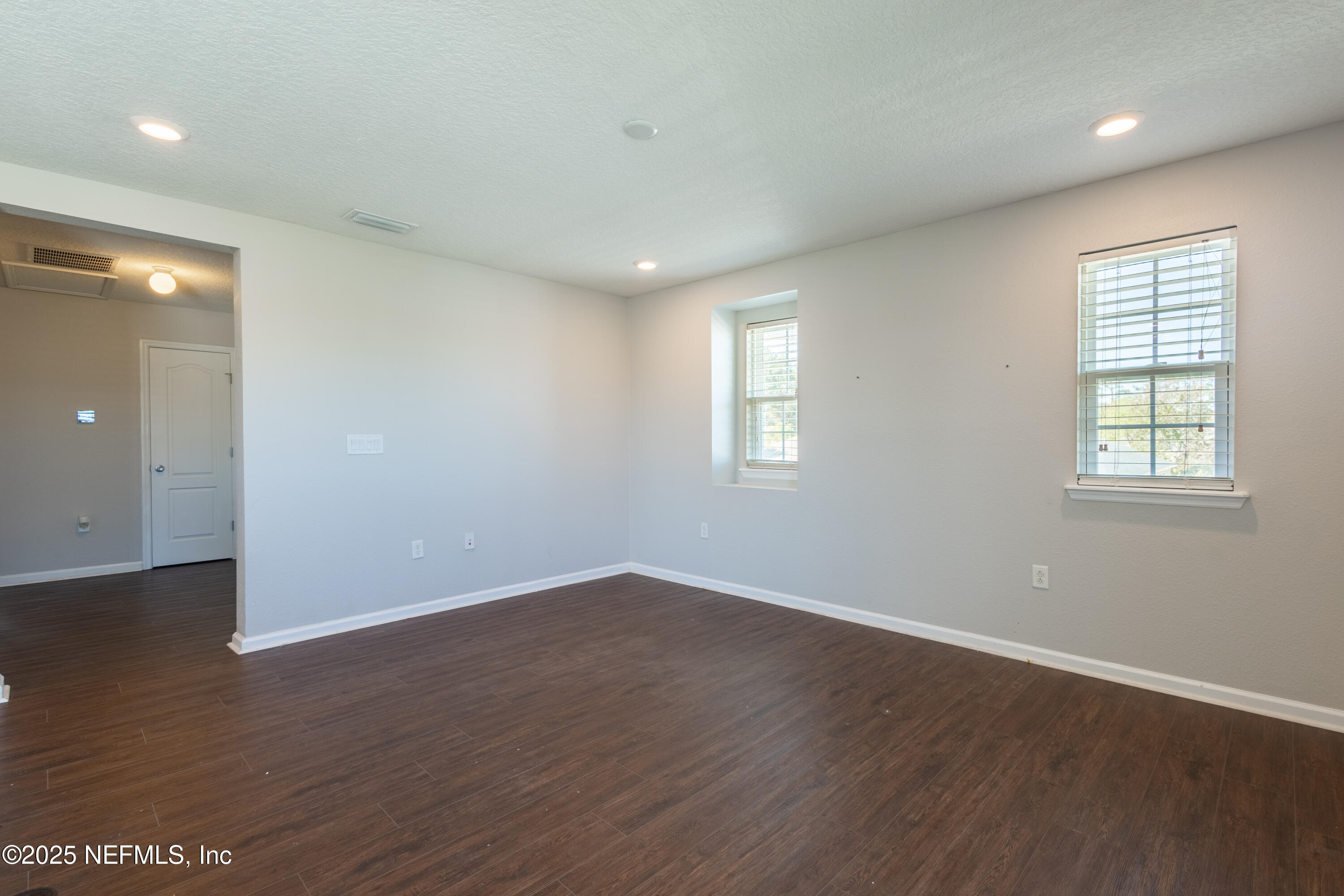 68 Redland Way Jacksonville, FL 32218 - Photo 23 of 40 an empty room with wooden floor and windows