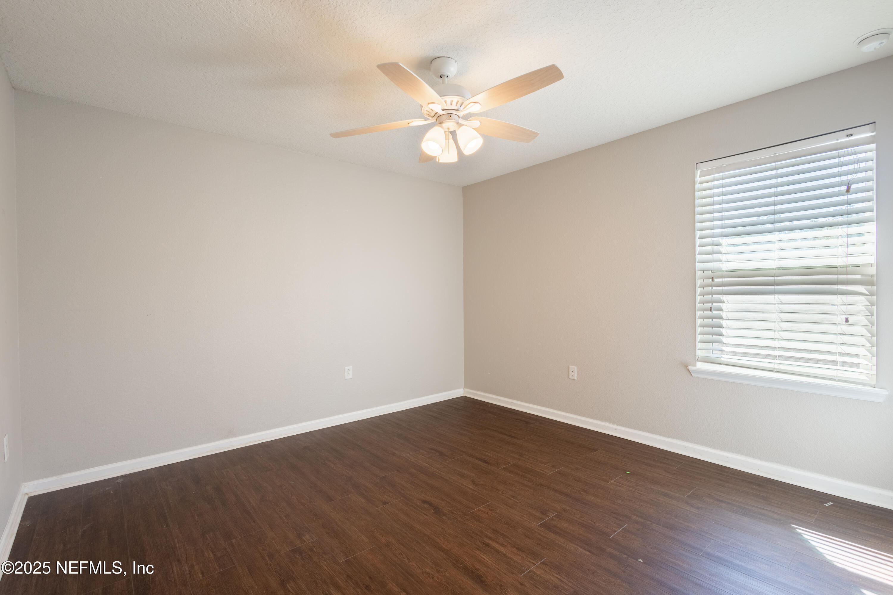 68 Redland Way Jacksonville, FL 32218 - Photo 24 of 40 an empty room with wooden floor fan and windows