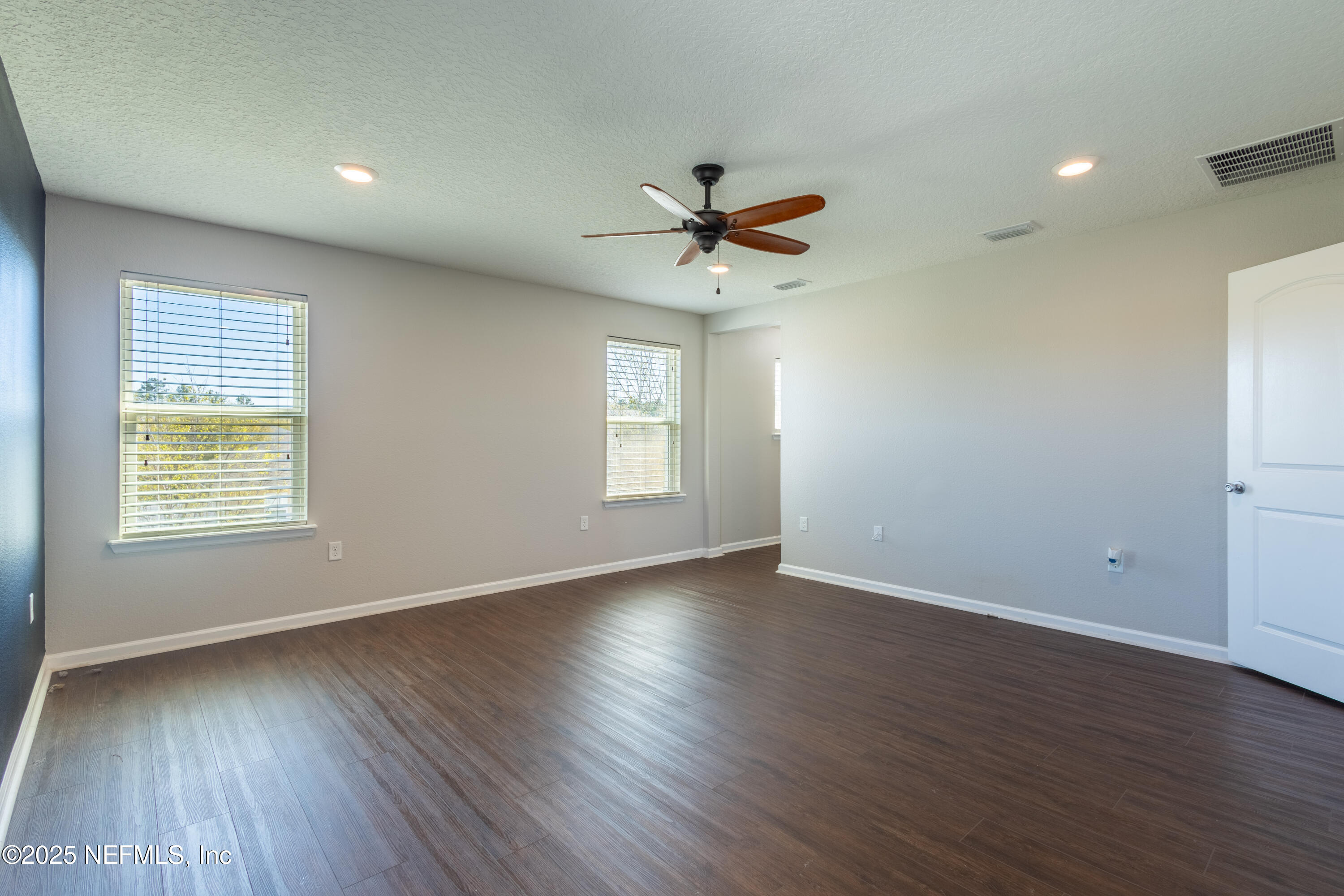 68 Redland Way Jacksonville, FL 32218 - Photo 31 of 40 an empty room with wooden floor and windows