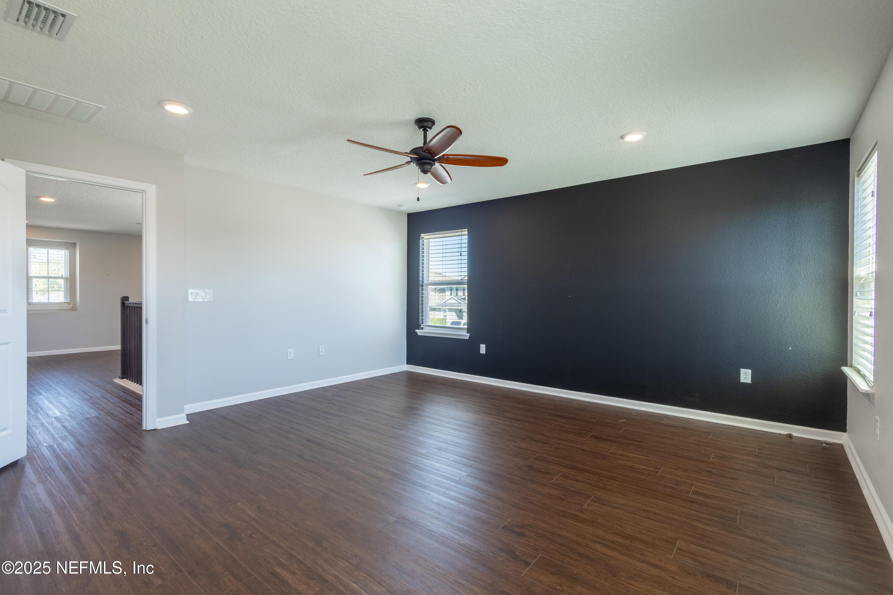 68 Redland Way Jacksonville, FL 32218 - Photo 33 of 40 a view of an empty room with wooden floor and a ceiling fan