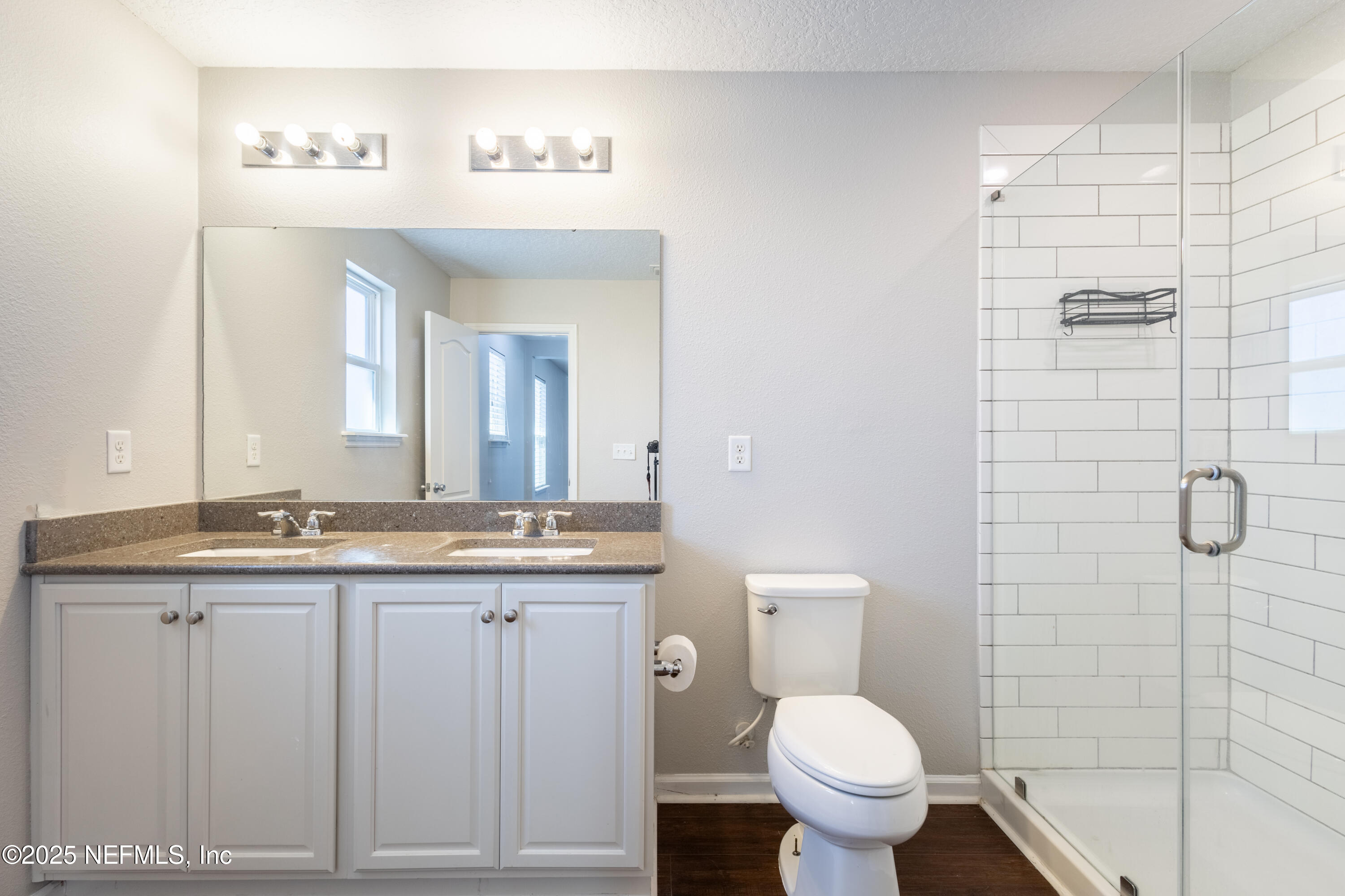 68 Redland Way Jacksonville, FL 32218 - Photo 34 of 40 a bathroom with a granite countertop toilet a sink and a mirror