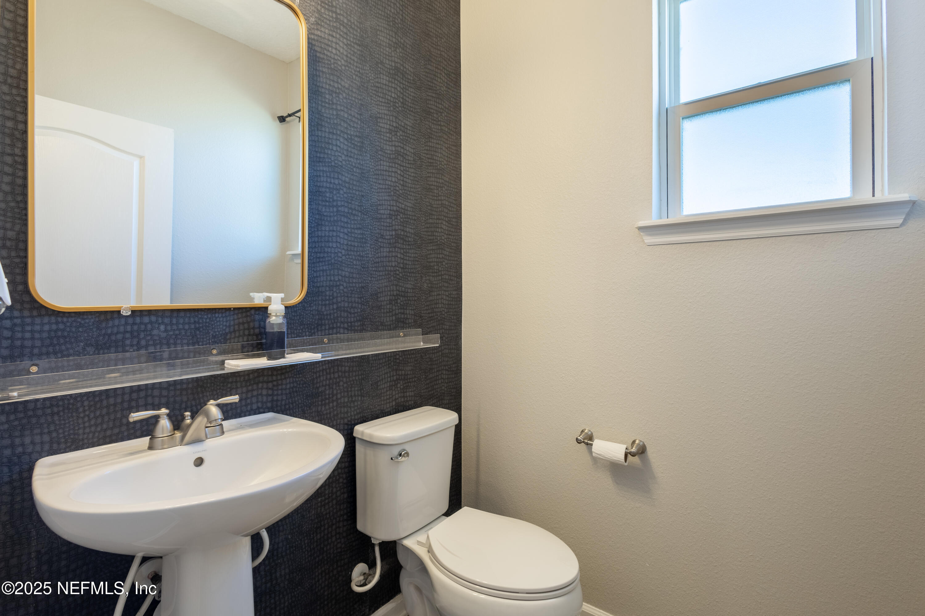 68 Redland Way Jacksonville, FL 32218 - Photo 9 of 40 a bathroom with a sink a toilet and mirror