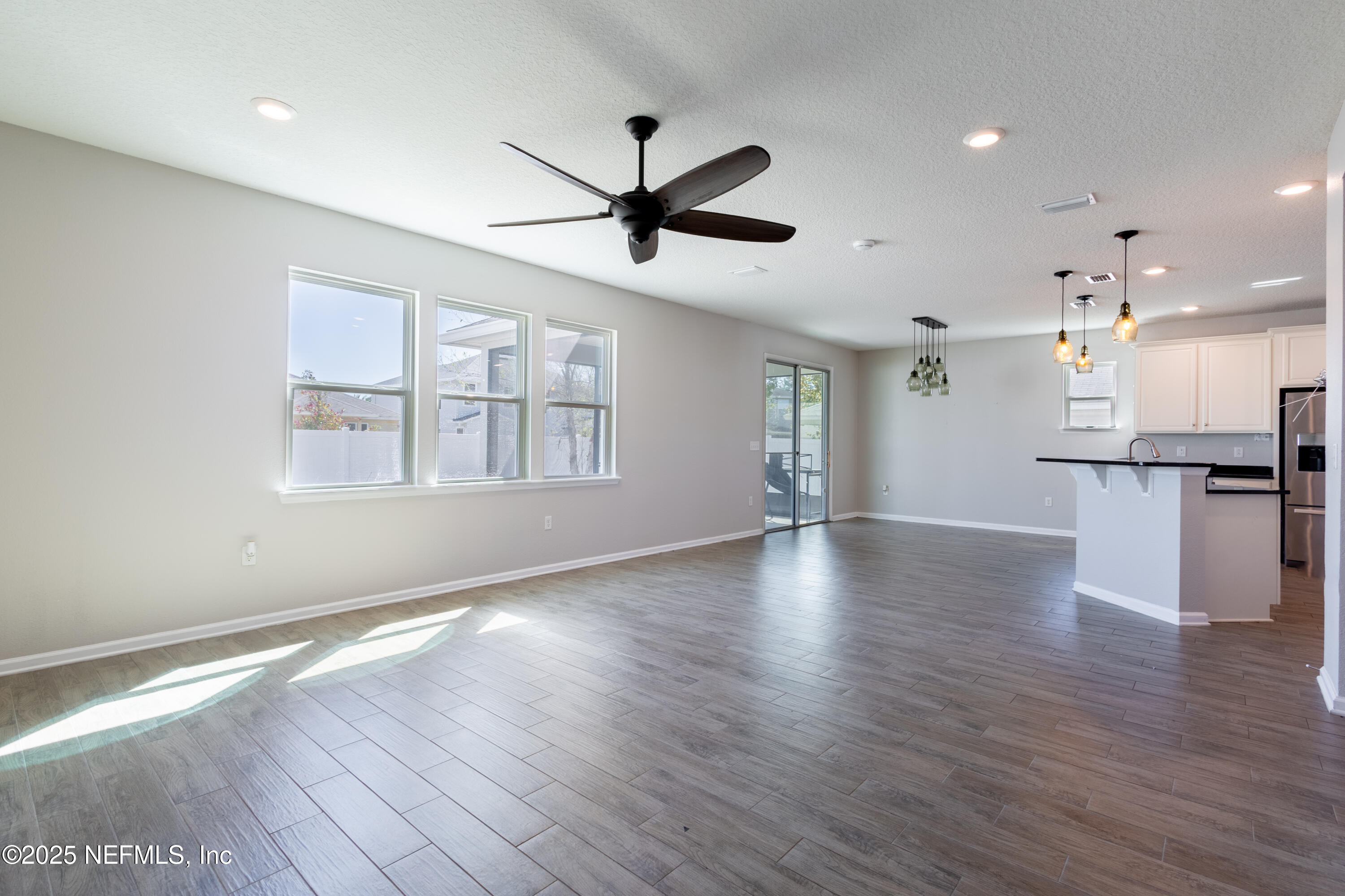 68 Redland Way Jacksonville, FL 32218 - Photo 10 of 40 a view of an empty room with window and wooden floor