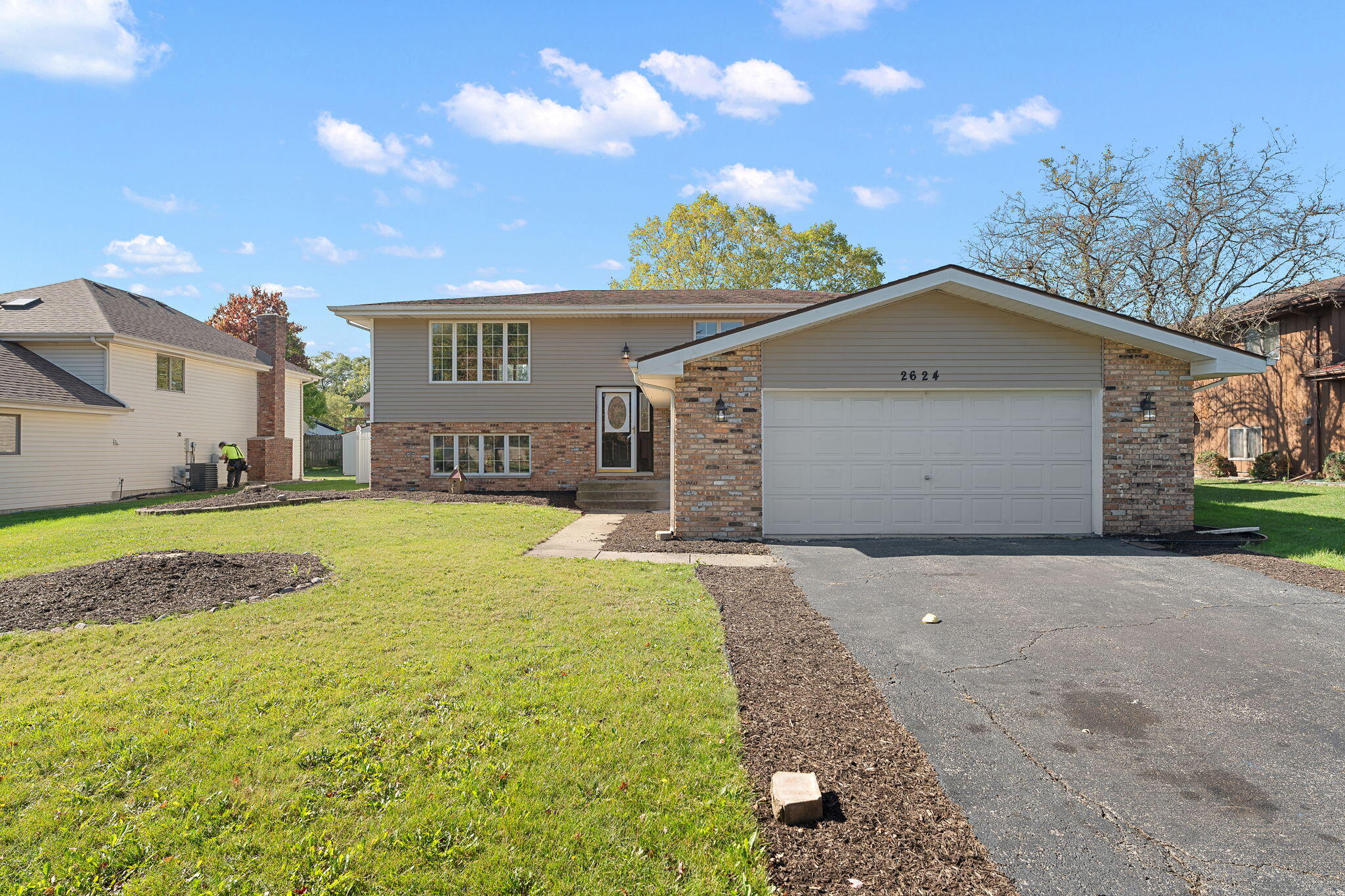 a view of a house with a yard and garage
