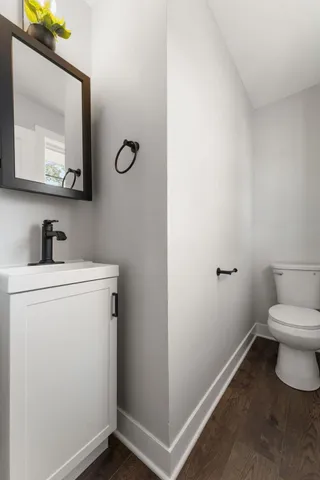 a bathroom with a toilet sink and mirror