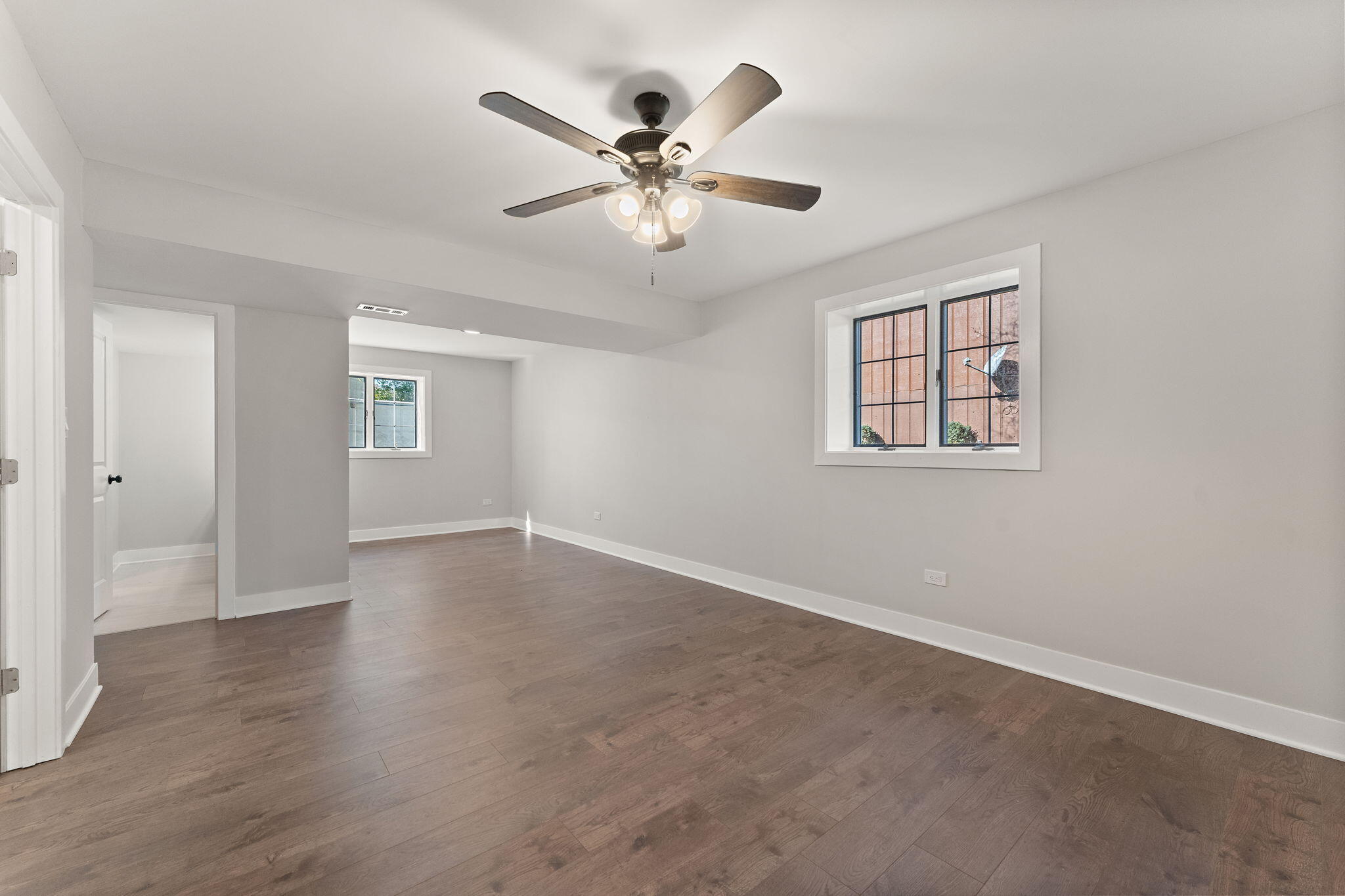 2624 Fossil Stone Road Dyer, IN 46311 - Photo 22 of 30 a view of an empty room with wooden floor and a ceiling fan