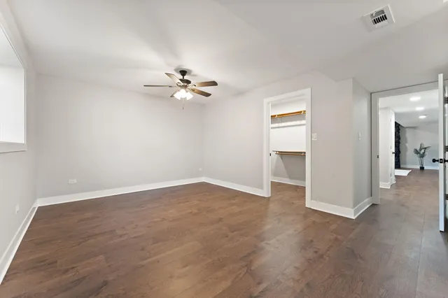 an empty room with fan and a ceiling fan