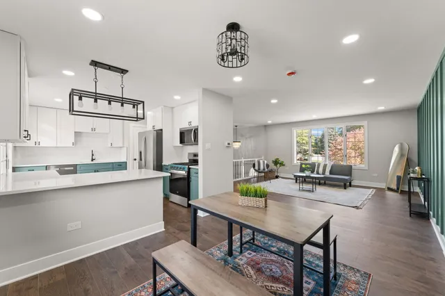 a kitchen with stainless steel appliances granite countertop a sink counter space and wooden floor