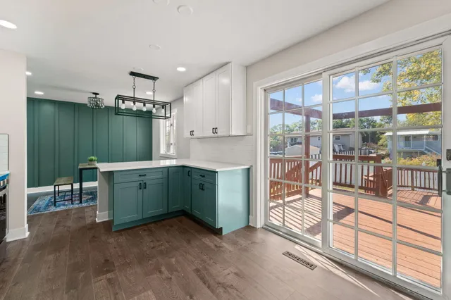 a kitchen with granite countertop a sink and a refrigerator