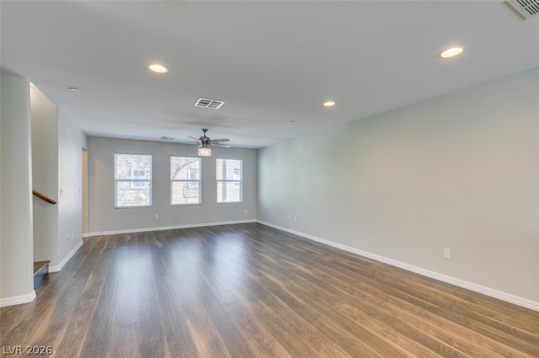 4650 Ranch House Road, Unit 46 North Las Vegas, NV 89031 - Photo 8 of 38 Polished wood-style floors and recessed lighting enhance this airy, open-concept living space.