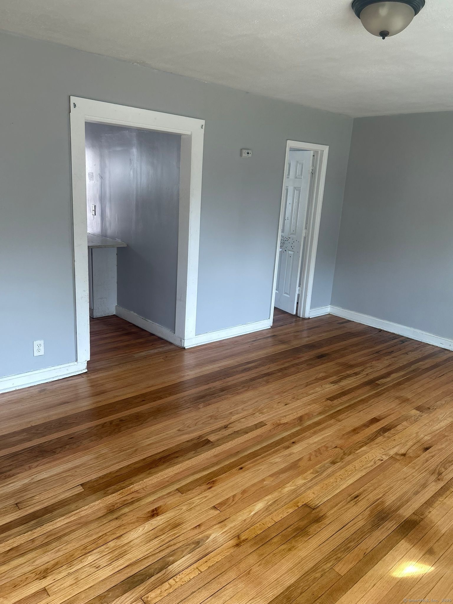 1575 Boston Avenue, Unit D17 Bridgeport, CT 06610 - Photo 2 of 3 a view of an empty room with wooden floor