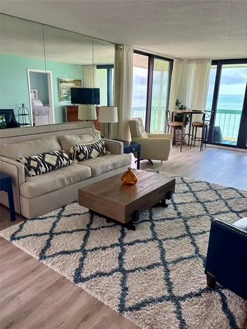 a living room with furniture and large windows