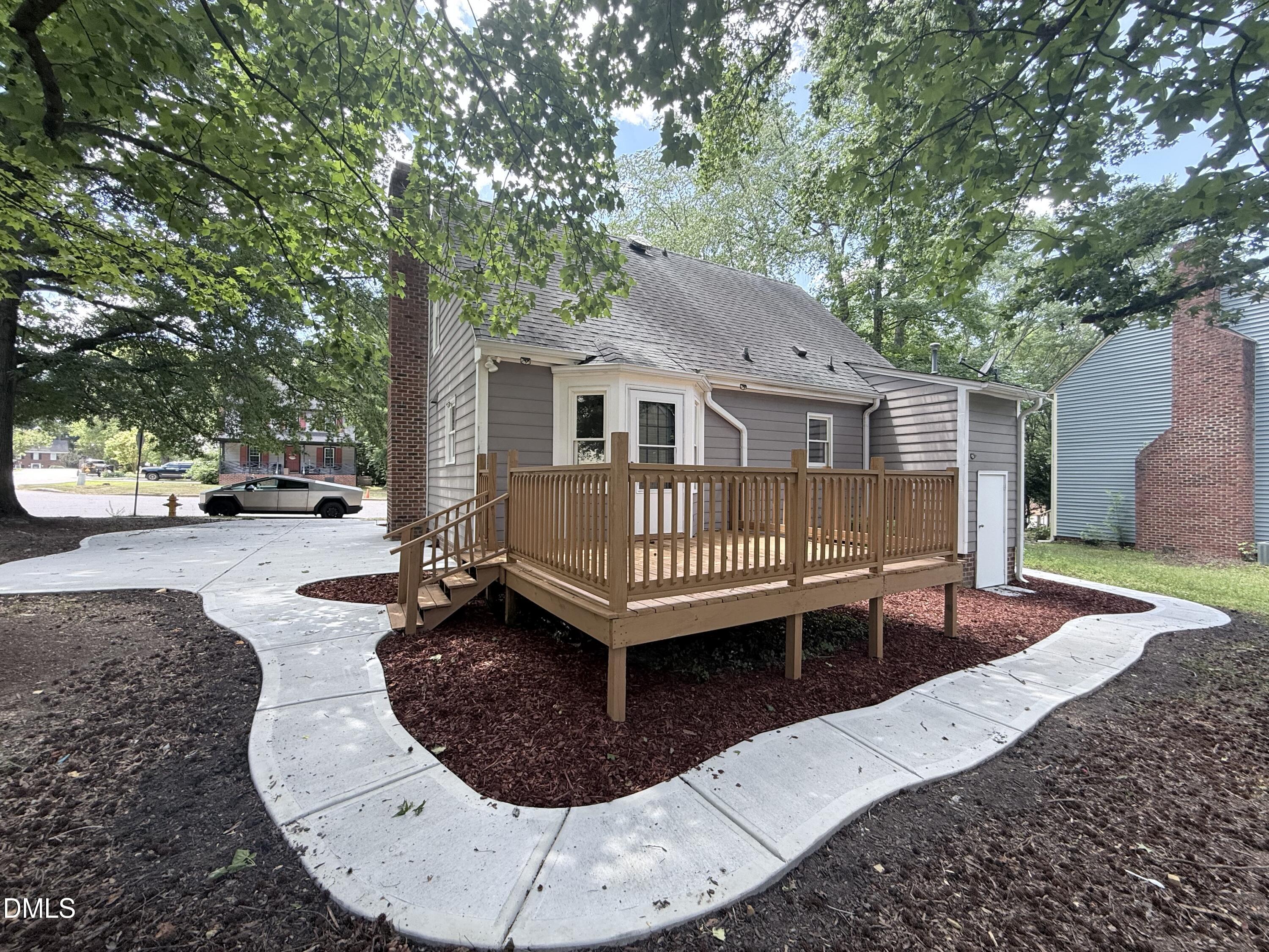 2900 Broadlands Drive Raleigh, NC 27604 - Photo 10 of 60 a view of a house with a patio and a yard