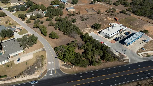 an aerial view of multiple houses with yard