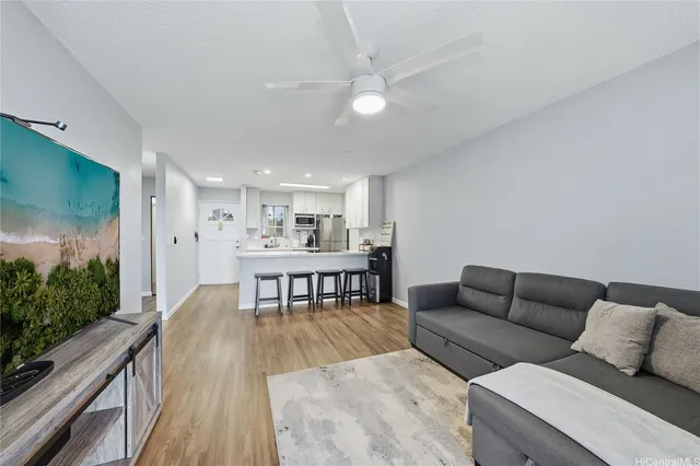 a living room with furniture and a wooden floor