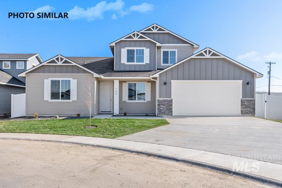 1644 Haystack Emmett, ID 83617 - Photo 1 of 33 Two-story residence featuring a two-car garage with stone detailing, a concrete driveway, and a front lawn