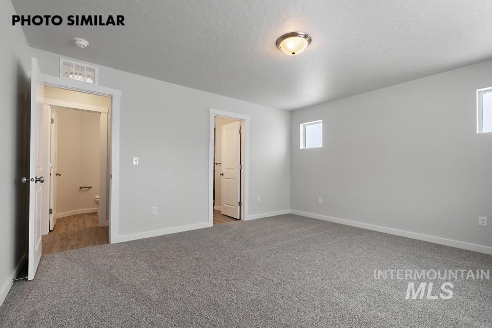1644 Haystack Emmett, ID 83617 - Photo 20 of 33 Spacious room featuring neutral gray carpeting and light gray wall paint