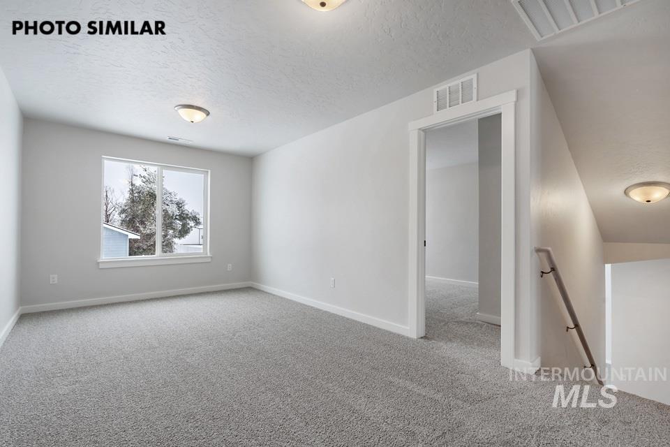 1644 Haystack Emmett, ID 83617 - Photo 21 of 33 Carpeted room with a large window and overhead lighting