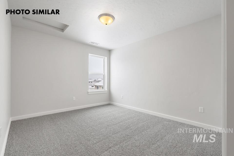 1644 Haystack Emmett, ID 83617 - Photo 25 of 33 Neutral gray walls complement the gray carpeting in this room featuring a single window and a flush-mount ceiling light fixture