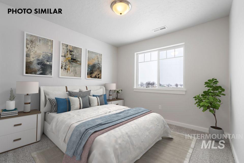 1644 Haystack Emmett, ID 83617 - Photo 28 of 33 Bedroom featuring a large window, neutral carpeting, light-toned wall paint, and an overhead flush-mount light fixture