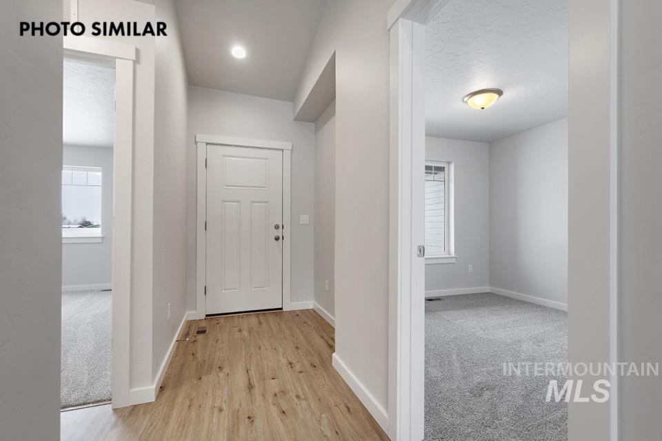 1644 Haystack Emmett, ID 83617 - Photo 2 of 33 Entryway featuring wood-finish flooring, a white paneled door with brushed nickel hardware, and a recessed ceiling light