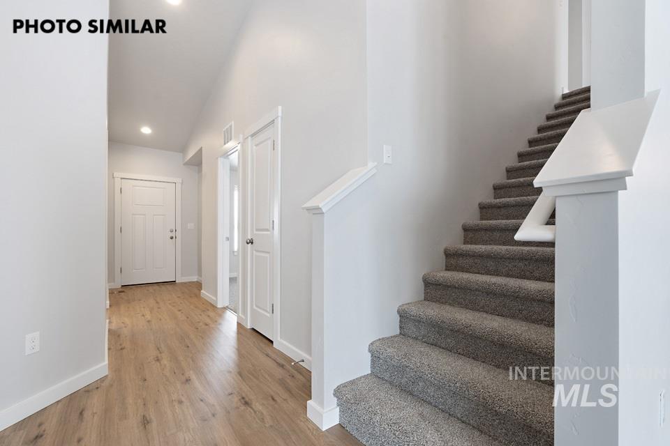 1644 Haystack Emmett, ID 83617 - Photo 3 of 33 Entryway featuring wood-finish flooring, recessed lighting, and a staircase with carpeted treads and a white newel post